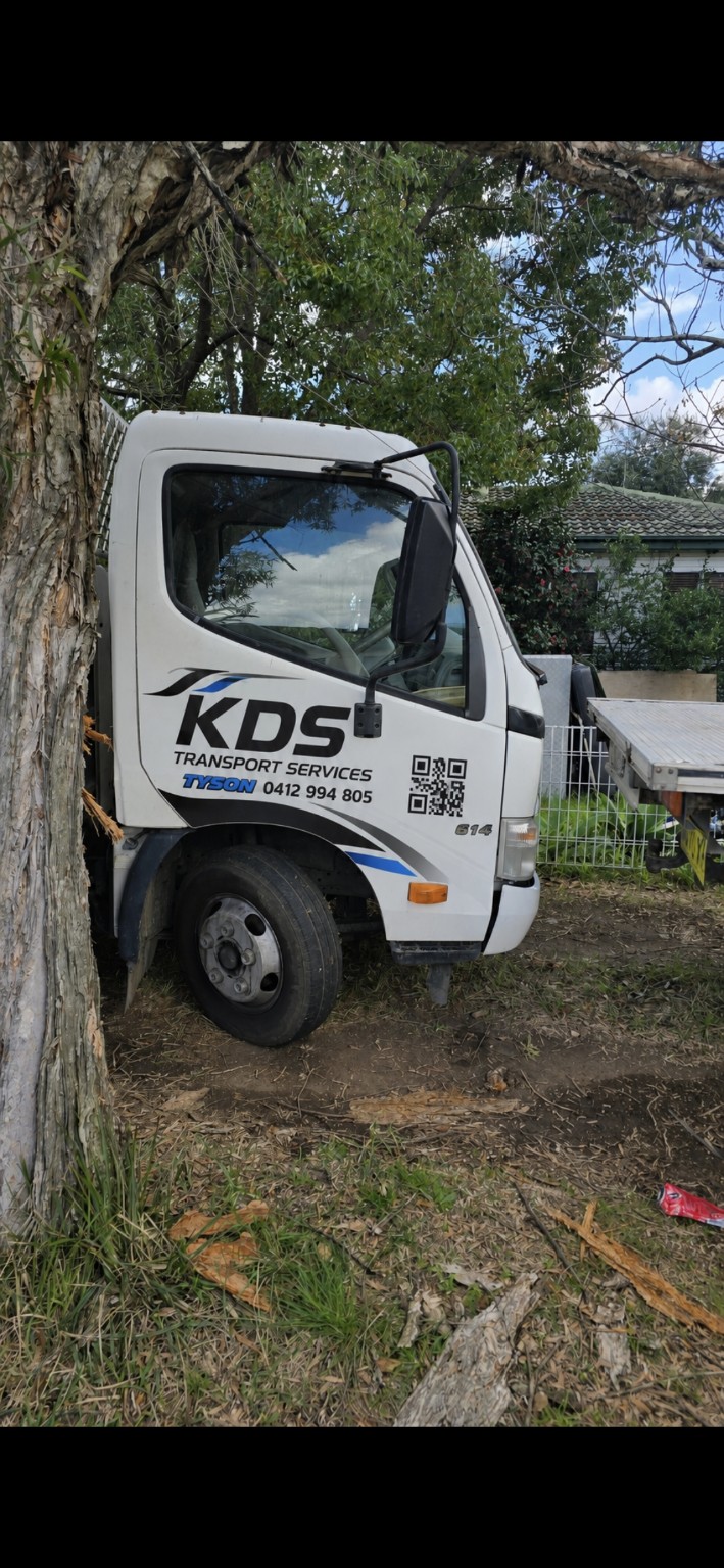 Tyson's white KDS Transport Services Hino 614 truck with branded door signage and QR code